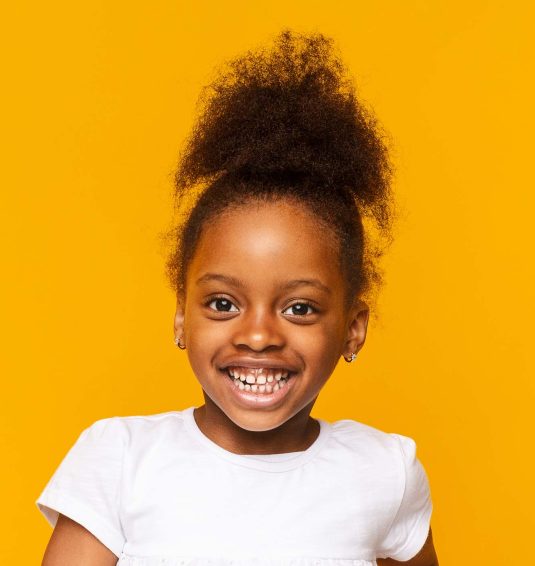 portrait-of-african-little-girl-smiling-over-GXAWB8R.jpg