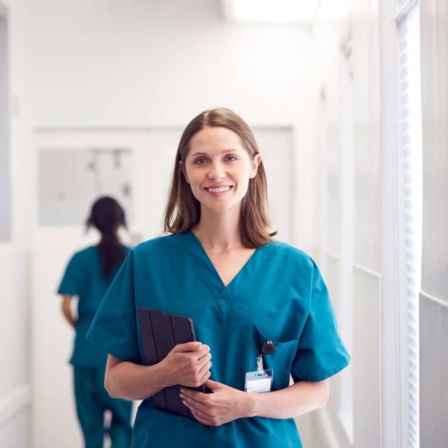 portrait-of-smiling-female-doctor-wearing-scrubs-HZ79GZQ-1.jpg